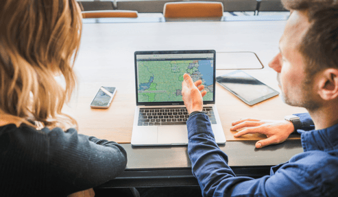 Guy pointing at a laptop screen