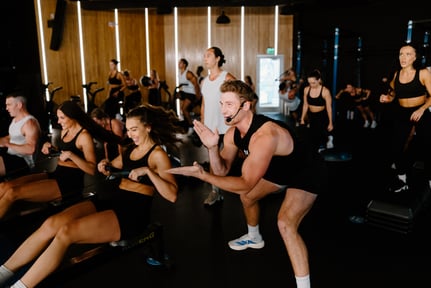 A man leading a group of people in a fitness class