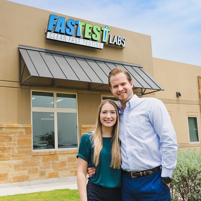 Fastest Labs franchisees stand side by side in front of the Fastest Labs building with logo.