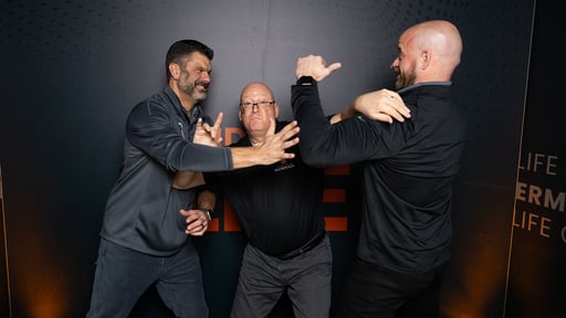 A photo of Ryan and Tyler fake fighting with Sidekick Advisor Tim in the middle