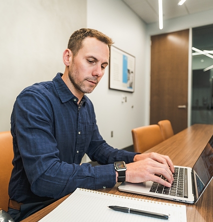 man working on laptop at table