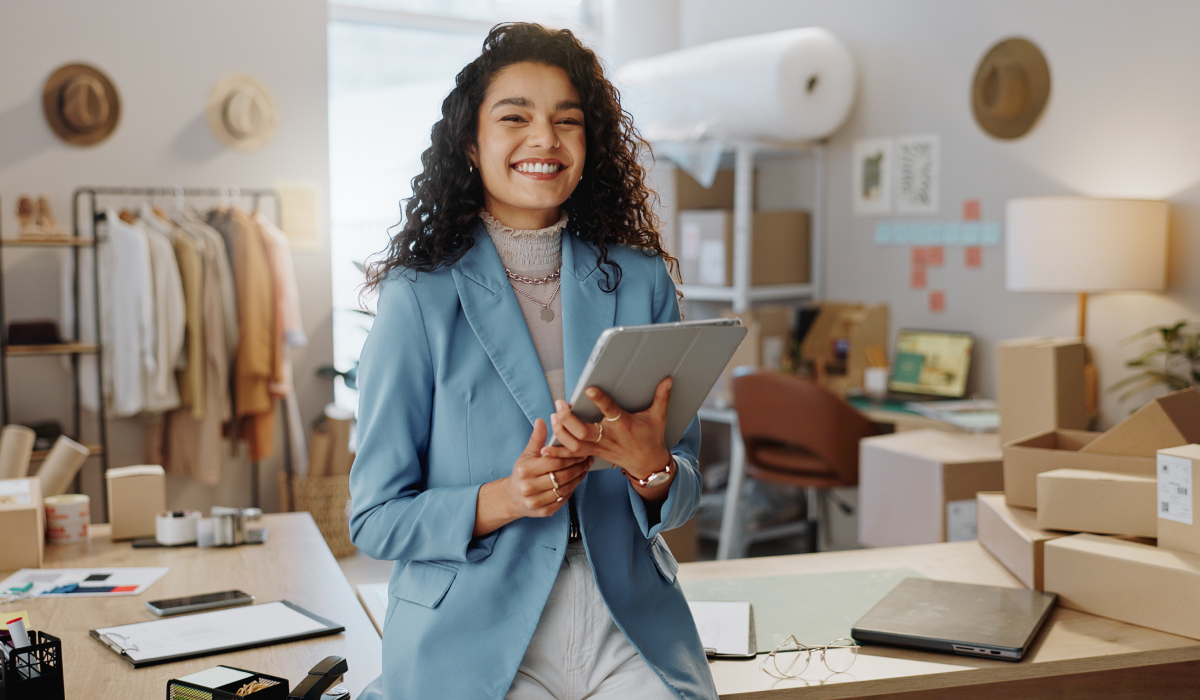 A girl smiling holding a tablet