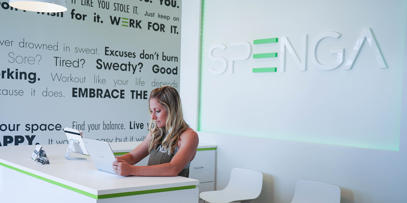 A woman sitting at a desk looking at her phone